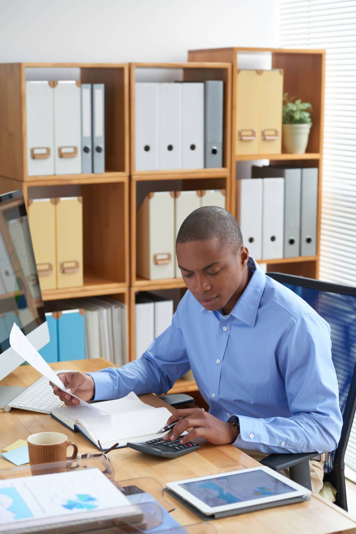 Financial manager working with documents and calculating expenses