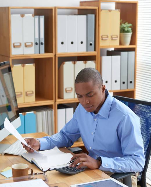 Financial manager working with documents and calculating expenses